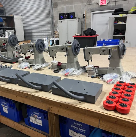 Portable walking-foot sewing machines used for professional inflatable repair training